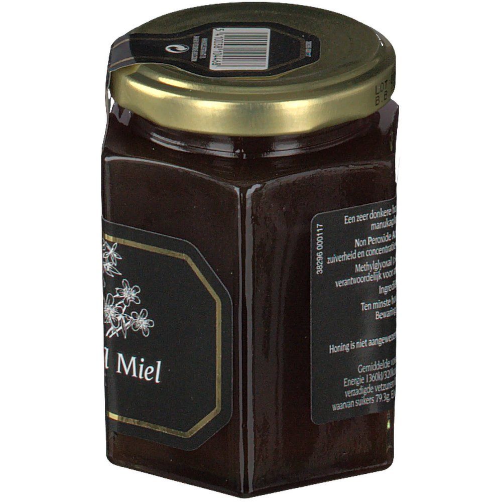 Zeshoekige pot honing met zwart etiket en gouden deksel. Etiket met bloemmotief en tekst.