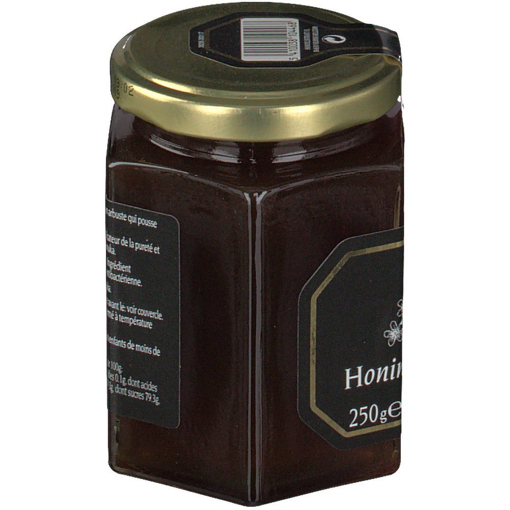Zeshoekige pot honing met zwart etiket en tekst. Gouden deksel. Opschrift 'Honing' en '250ge'.