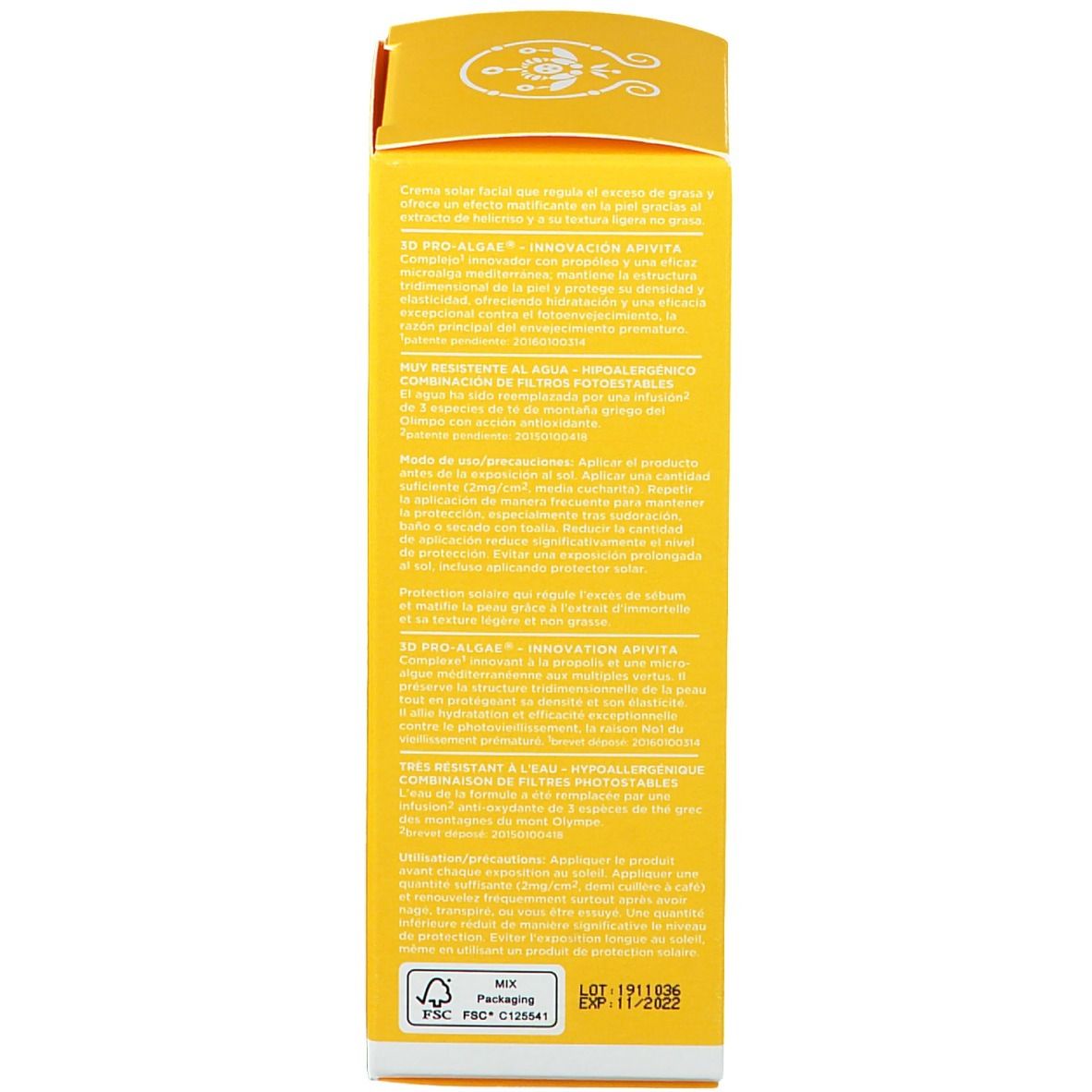 Dos d'une boîte de crème solaire jaune. Texte avec informations sur le produit et ingrédients.