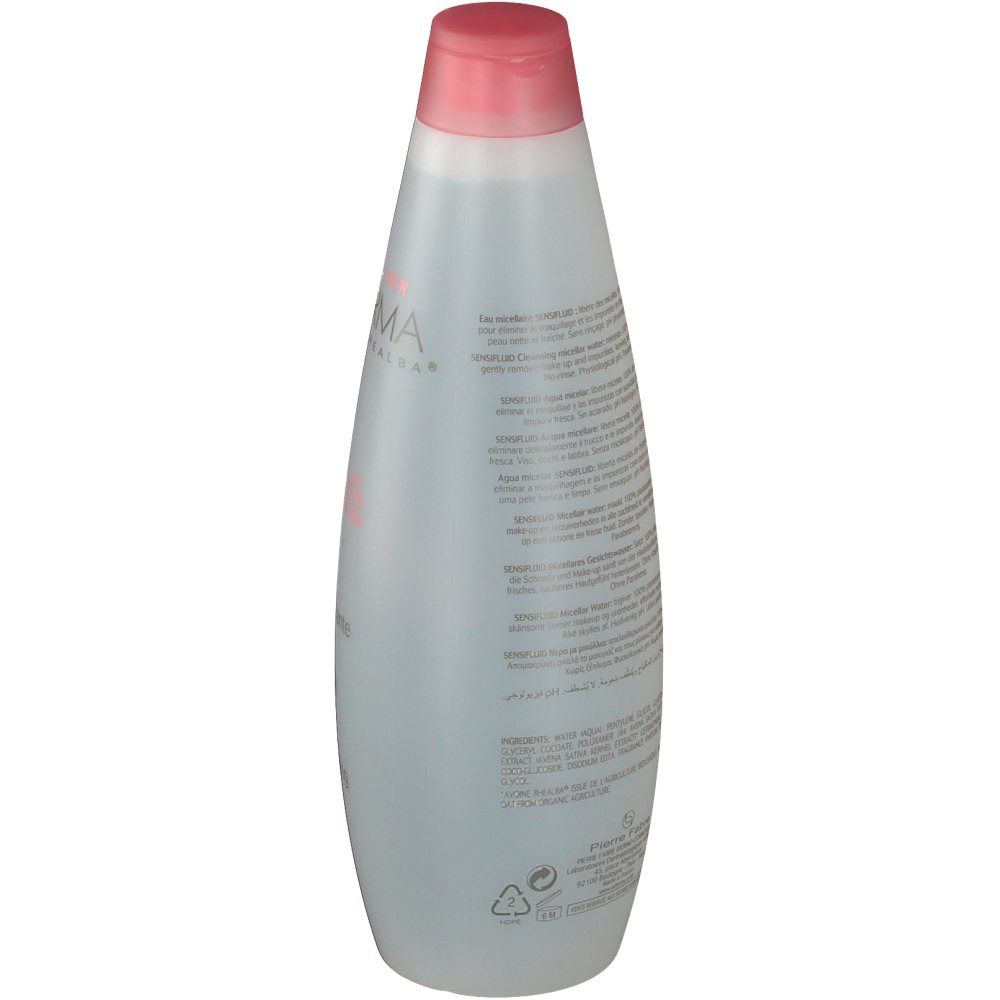 Flacon transparent avec bouchon rose. Texte sur le flacon. Étiquette avec informations et code-barres.