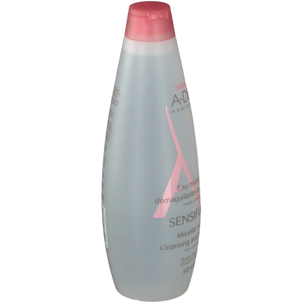 Flacon transparent avec bouchon rose. Logo A-DERMA et nom du produit SENSIFLUID. Texte sur le flacon.