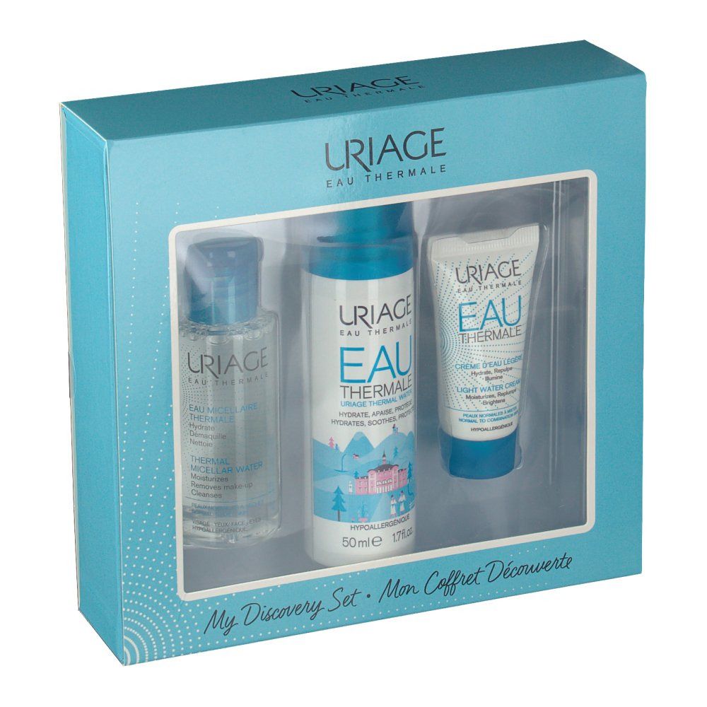 Lichtblauwe doos met drie Uriage-producten. Venster toont flessen en tube. Opschrift Uriage Eau Thermale.