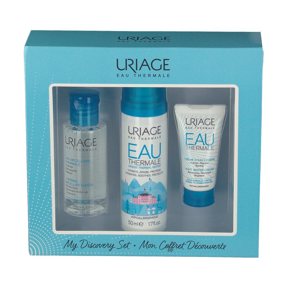 Lichtblauwe doos met drie Uriage-producten. Venster toont flessen en tube. Opschrift Uriage Eau Thermale.