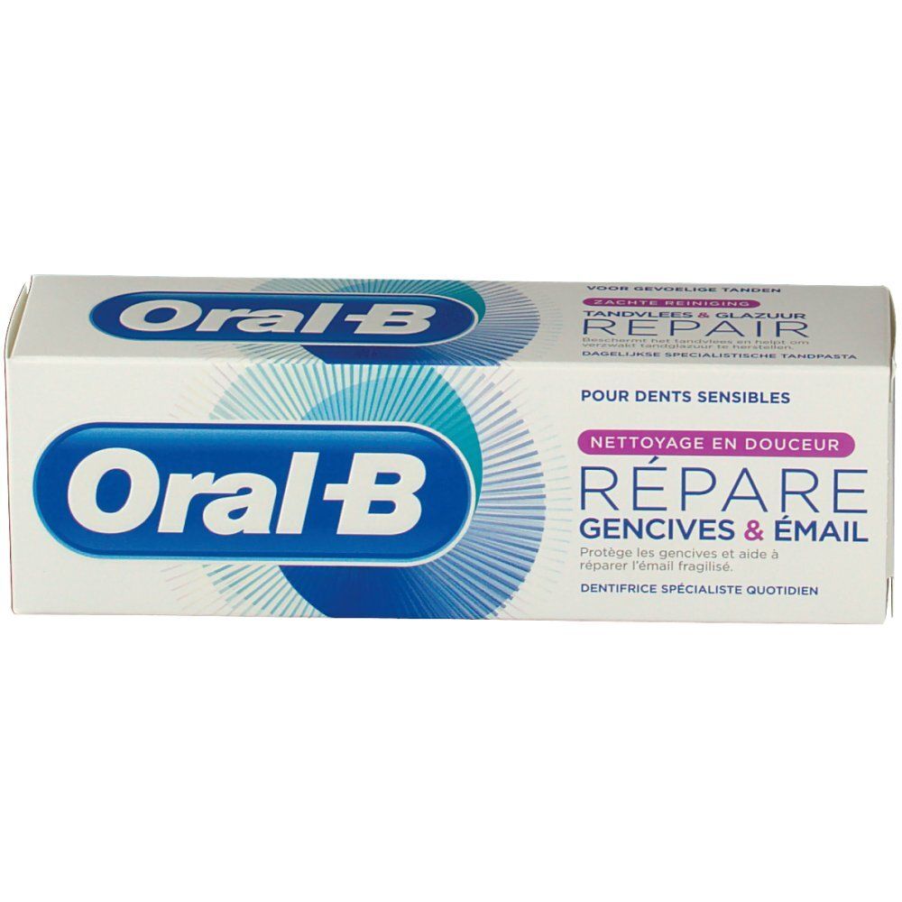 Tandpastaverpakking. Wit, met blauw logo en tekst. "Réparer gencives & émail" en "Oral-B" zichtbaar.