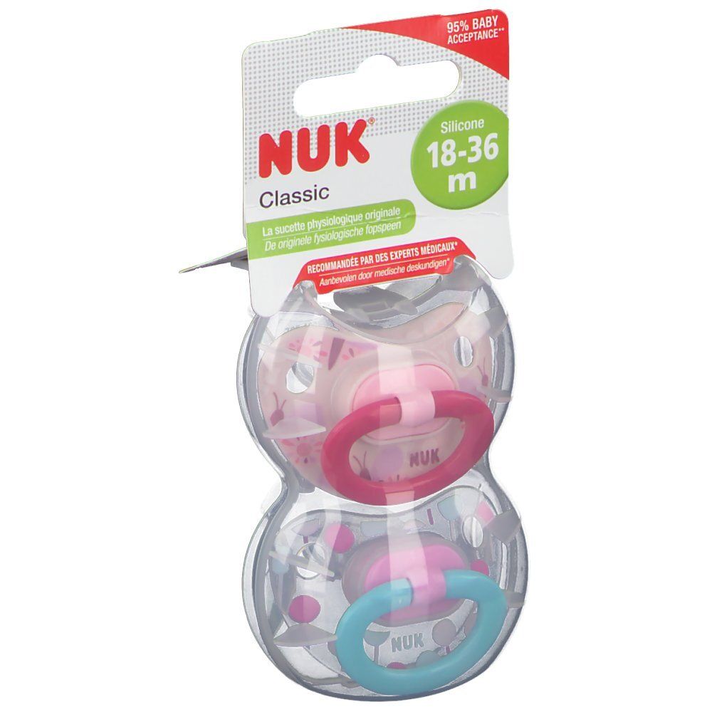 Deux sucettes NUK Classic en silicone, 18-36 mois. Emballage avec suspension. Anneaux rose et bleu.