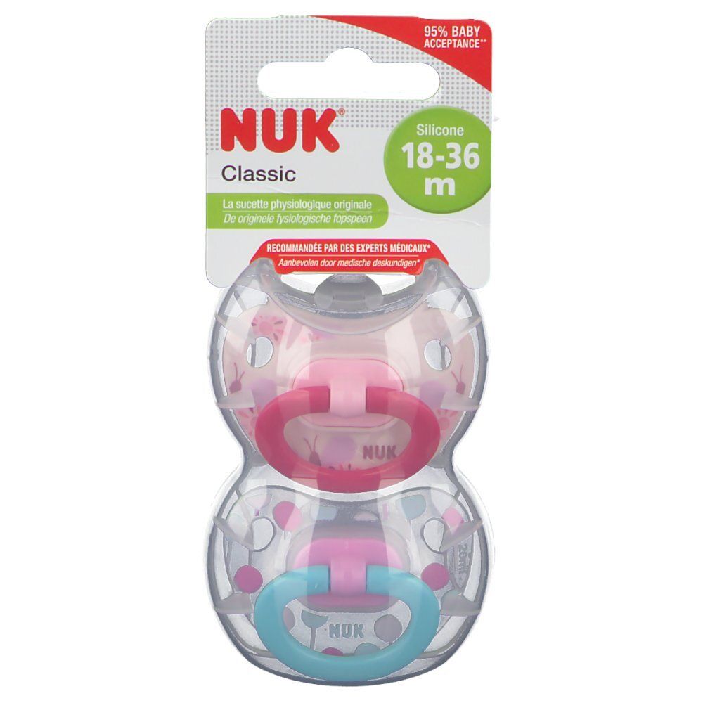Deux sucettes NUK Classic en silicone, 18-36 mois. Emballage avec suspension. Anneaux rose et bleu.
