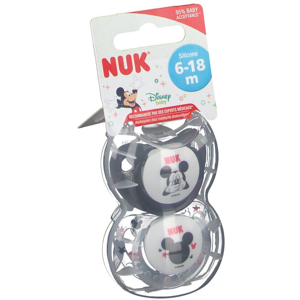 Deux sucettes Mickey Mouse dans un emballage transparent. L'emballage porte le logo NUK et une recommandation d'âge.