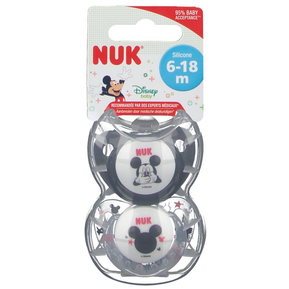 Deux sucettes Mickey Mouse dans un emballage transparent. L'emballage porte le logo NUK et une recommandation d'âge.