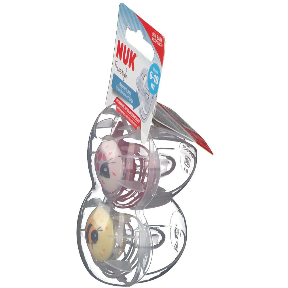 Twee NUK Freestyle fopspenen, 6-18 maanden, in verpakking. Zijaanzicht. Roze en gele motieven.