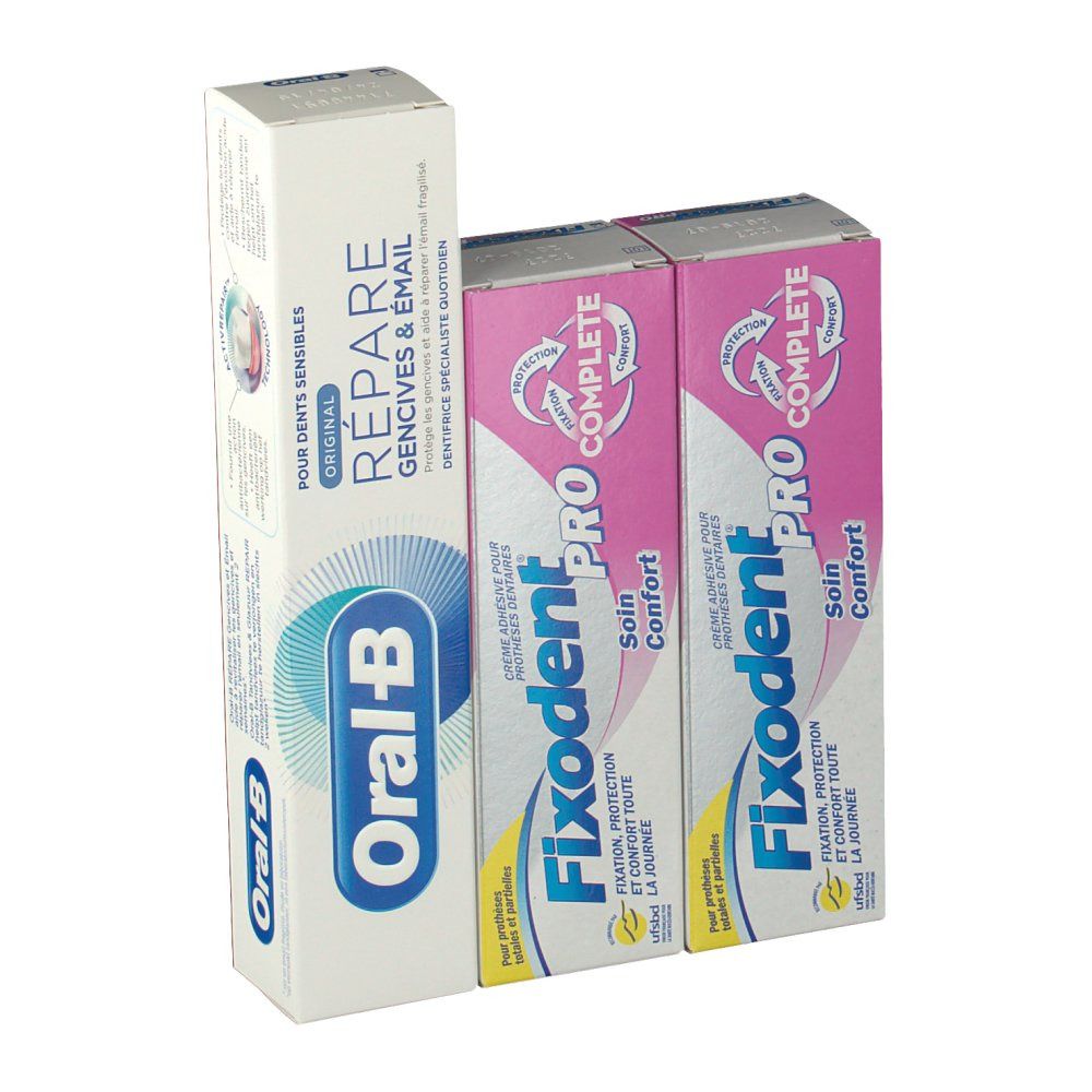 Verpakkingen van tandpasta en kleefcrème. Oral-B tandpasta en twee Fixodent Pro Complete verpakkingen. Roze en witte verpakkingen.