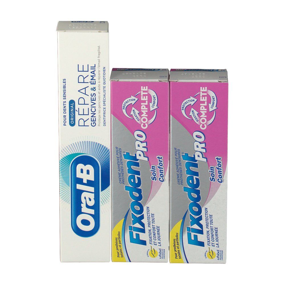 Verpakkingen van tandpasta en kleefcrème. Oral-B tandpasta en twee Fixodent Pro Complete verpakkingen. Roze en witte verpakkingen.