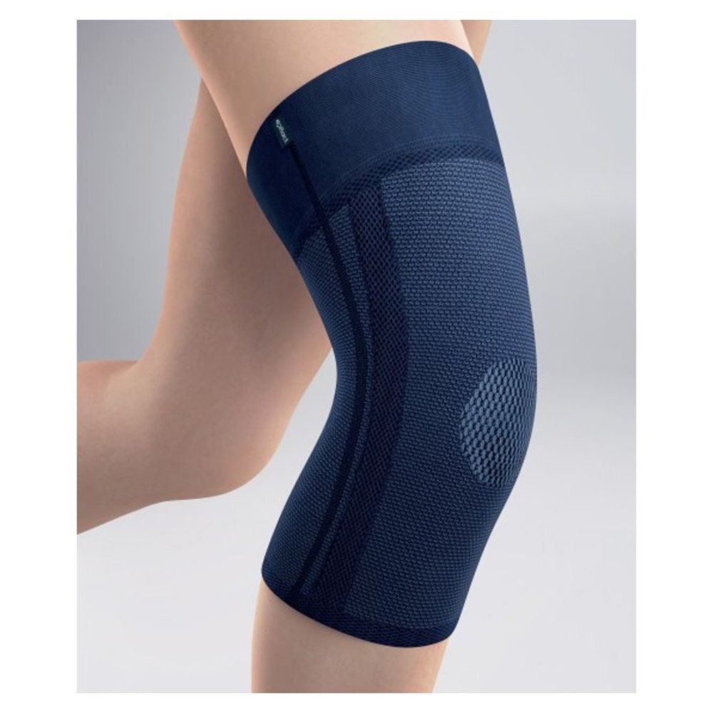 Genouillère bleue foncée sur une jambe. Surface texturée, articulation du genou ouverte. Petit logo vert.