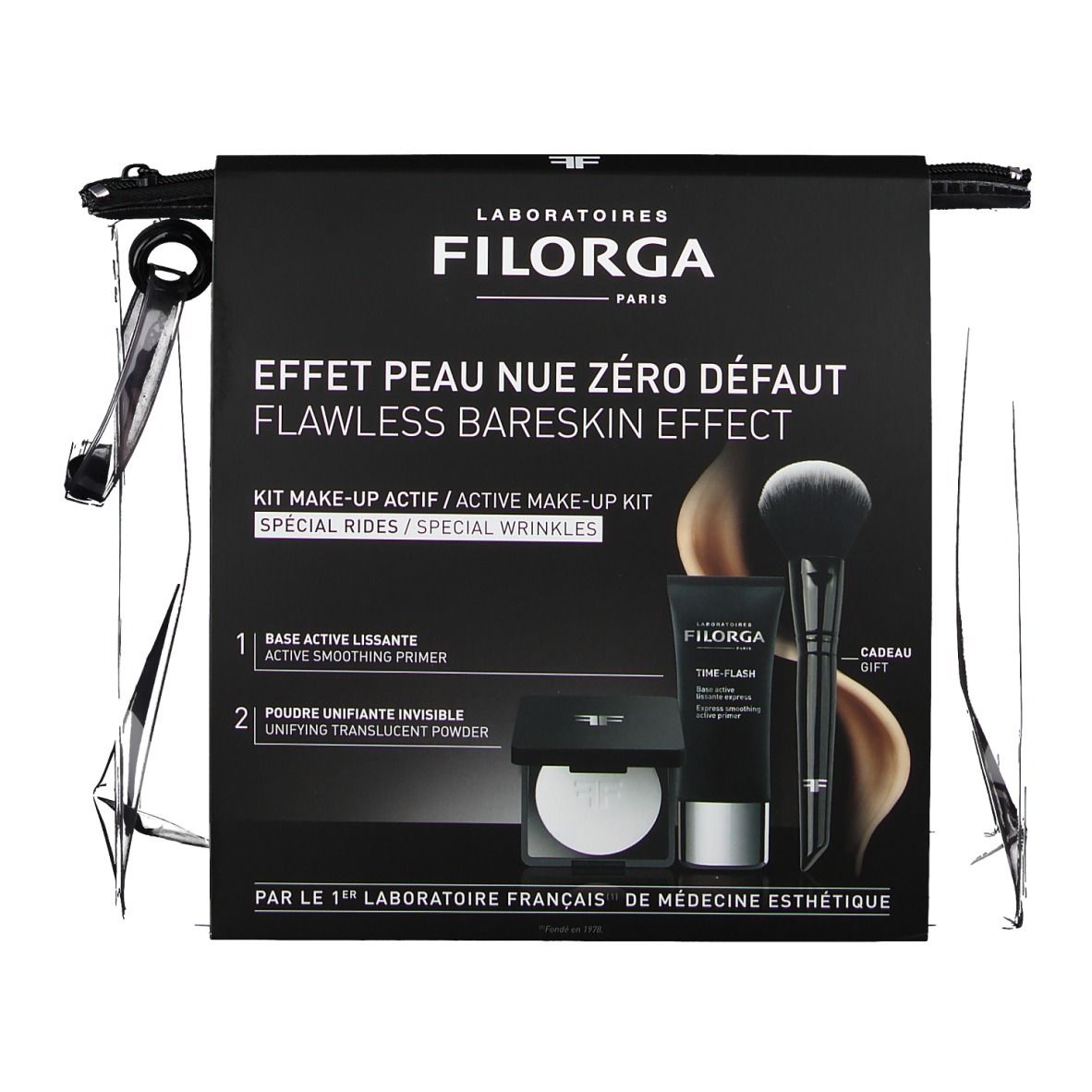 Emballage avec produits. Emballage noir avec texte et produits. Contient pinceau, tube et poudre. Marque : FILORGA.