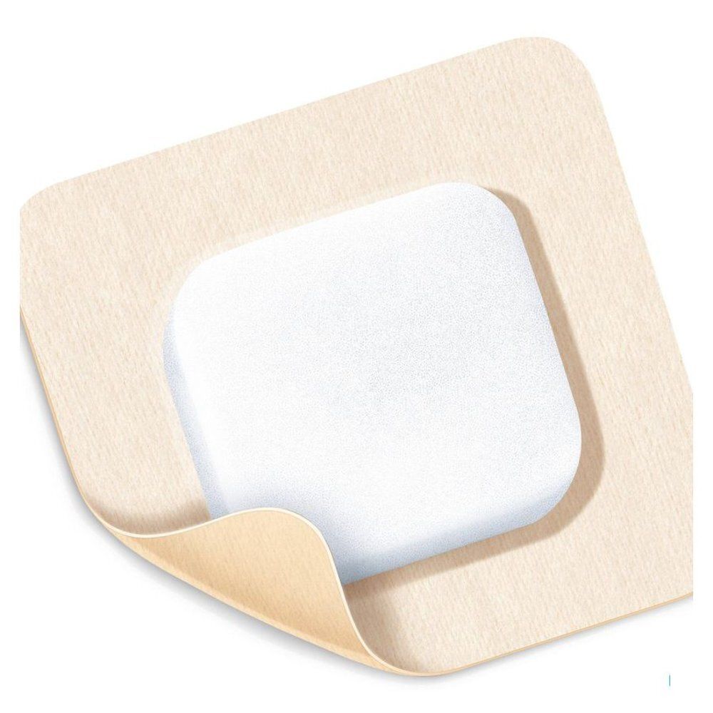 Pansement carré avec mousse blanche et bord adhésif beige. Un coin est soulevé.