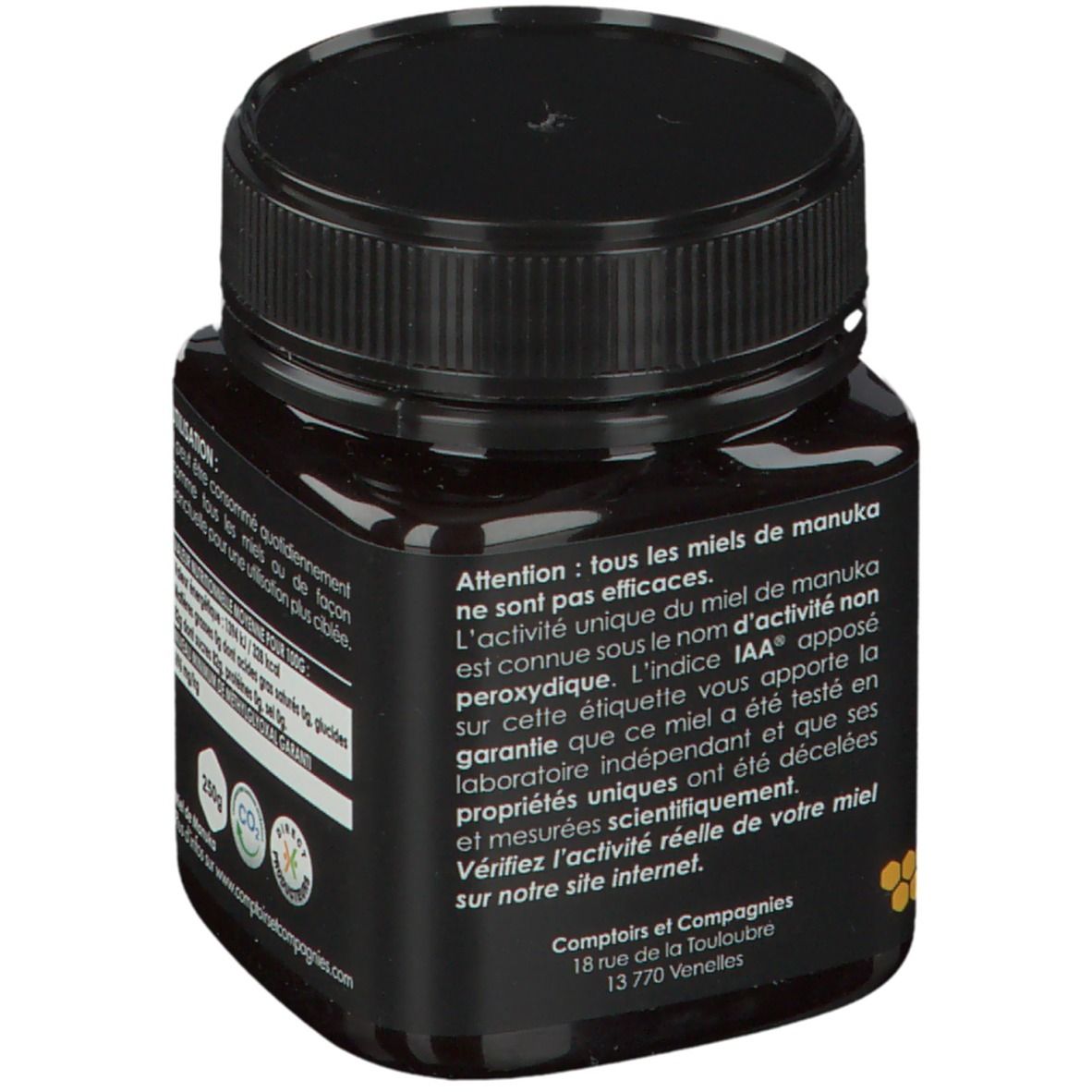 Zwarte pot honing met etiket. Opschrift: Informatie over gebruik en ingrediënten.