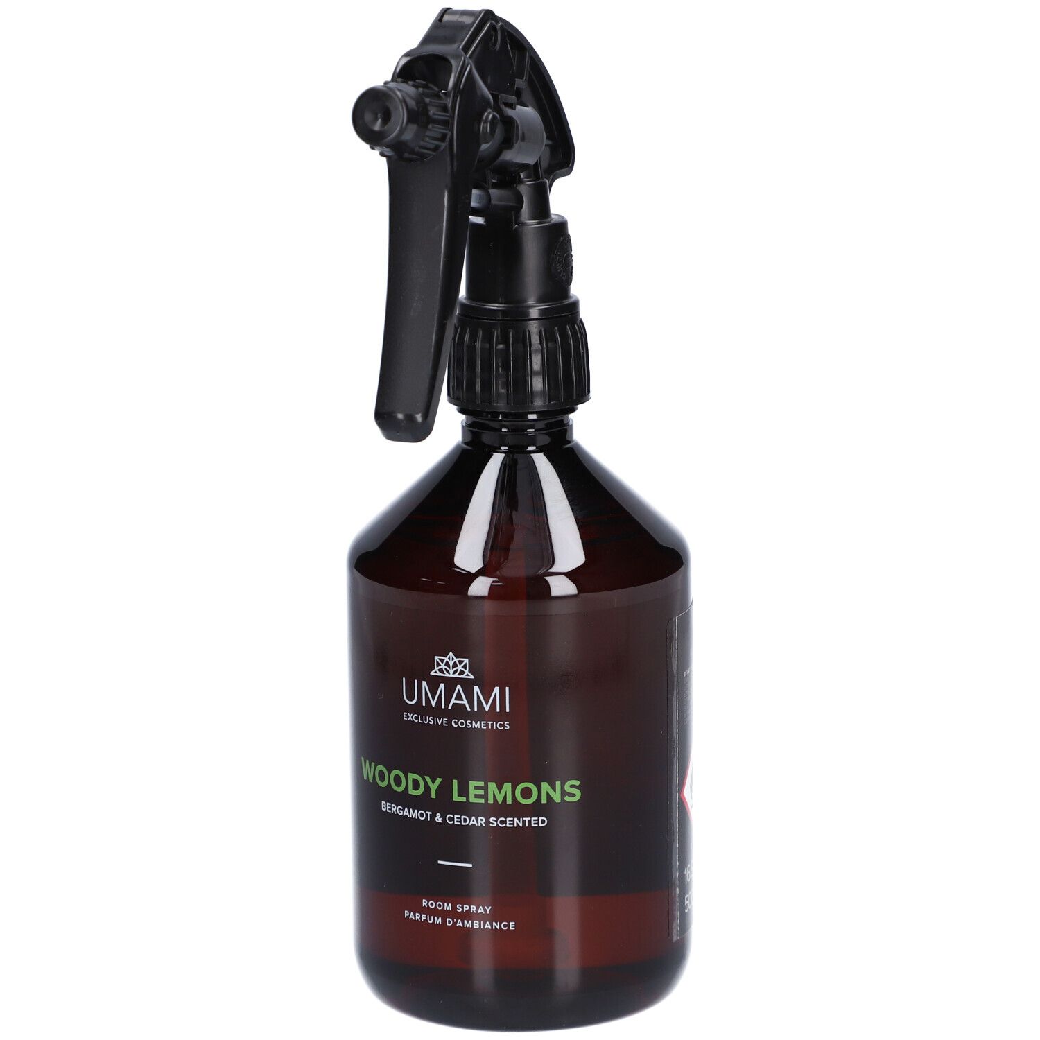 Flacon pulvérisateur brun avec tête noire. Inscription: UMAMI, Woody Lemons, Bergamote & Cèdre Scented.
