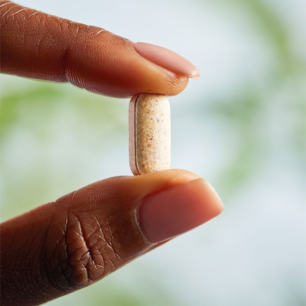 Hand houdt een langwerpige tablet tussen de vingers.