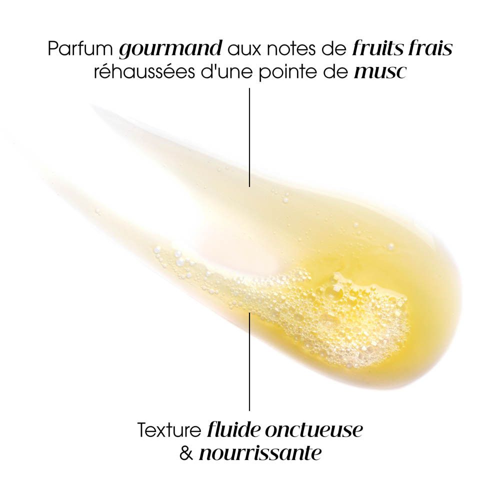 Démonstration de texture. Texture jaune crémeuse avec texte: 'Parfum gourmand aux notes de fruits frais rehaussées d'une pointe de musc'.
