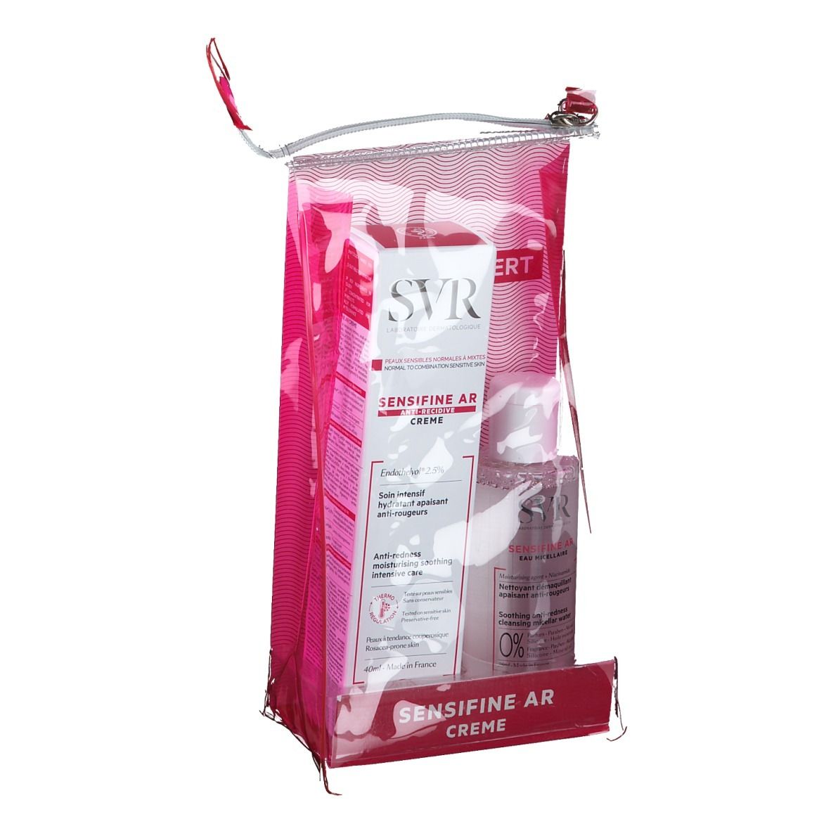 Set dans un sac transparent rose. Comprend une boîte blanche et rouge et un flacon transparent avec un bouchon blanc. Marque SVR visible.