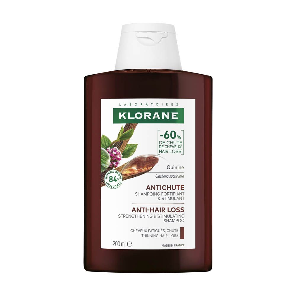 Bruine shampoo fles met witte dop. Opschrift: KLORANE, Anti-haaruitval. -60% haaruitval.