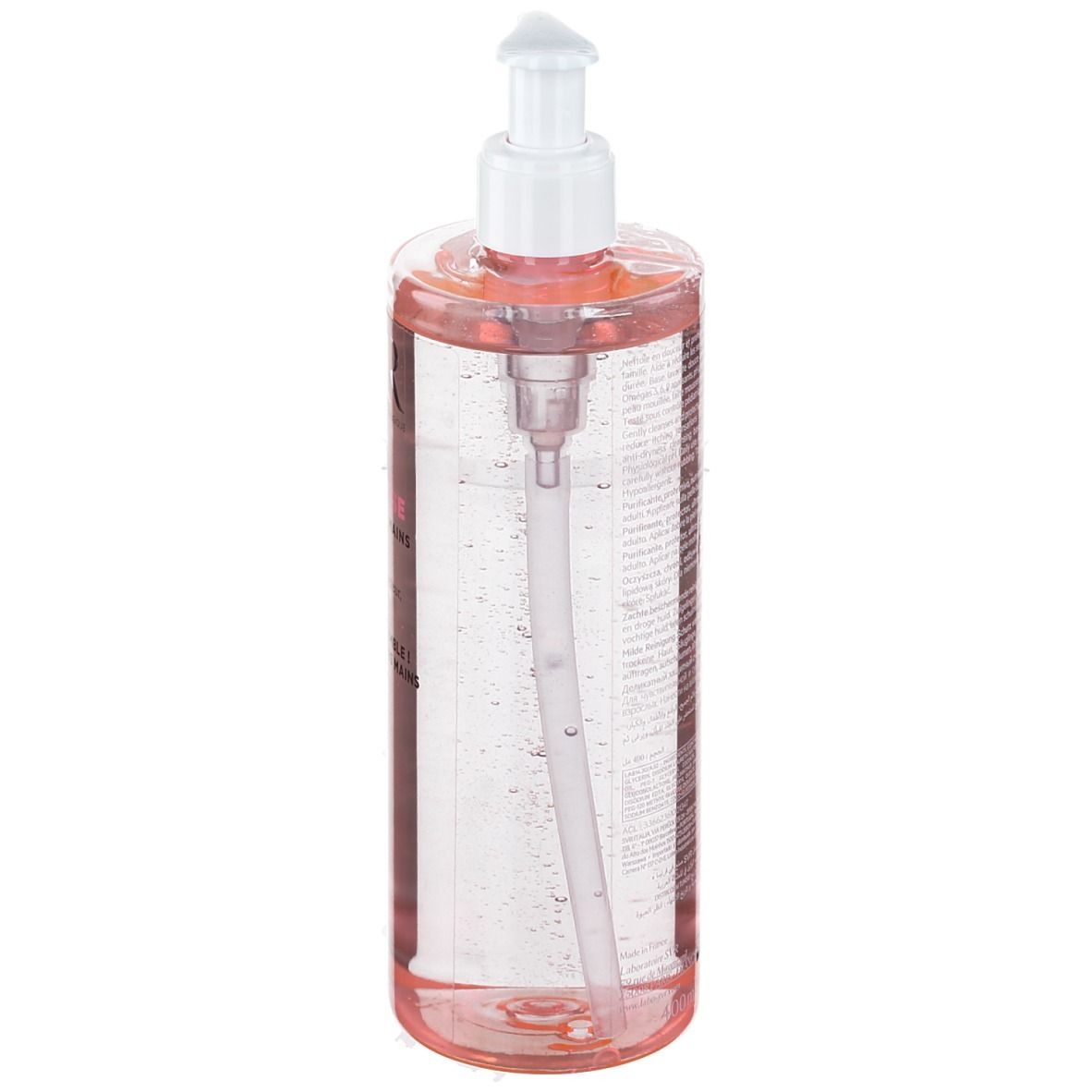 Transparante fles met roze vloeistof en witte pomp. Het pompmechanisme is zichtbaar.