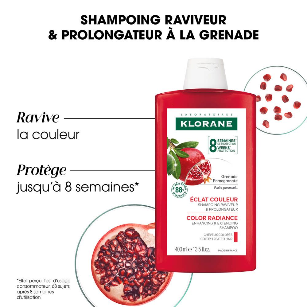 Flacon de shampooing rouge avec bouchon blanc. Étiquette avec grenade et texte.