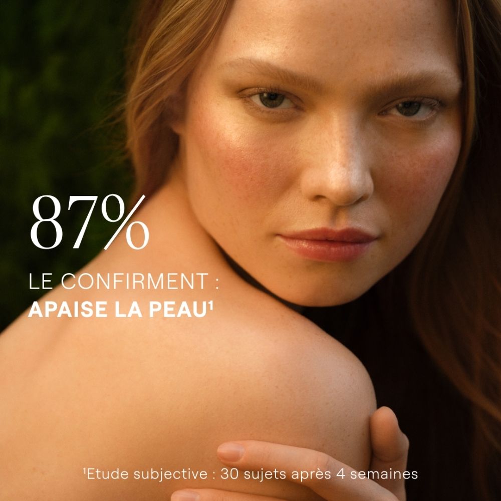 Femme à la peau radieuse, confirmant 87% d'apaisement de la peau.