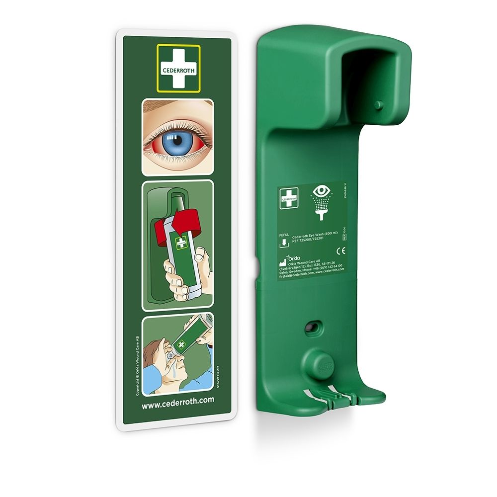 Groene wandhouder voor oogspoeling met bijgevoegd instructiebord. CE-markering zichtbaar.