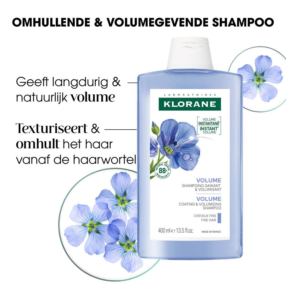 Blauwe fles Klorane Volumenshampoo Flachs. Lijnzaadbloemen en productinfo. Witte dop. 400 ml.