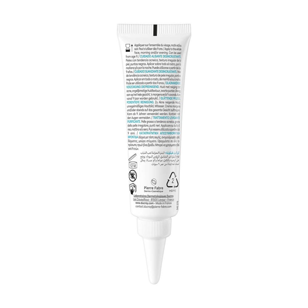 Achterkant van de tube Ducray Keracnyl Glycolic+ crème. Meertalige tekst. Wit.