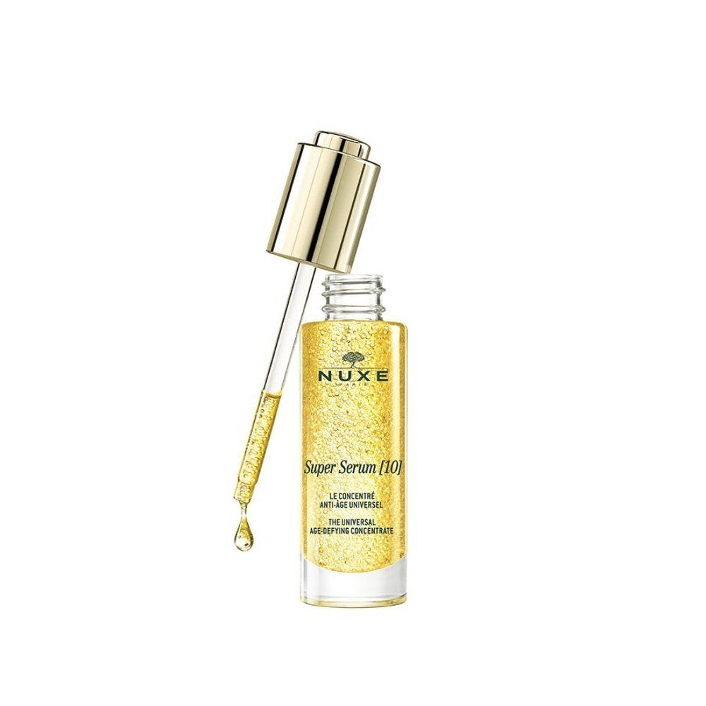Nuxe Super Serum fles met pipet die een druppel afgeeft. Geel serum met bolletjes.