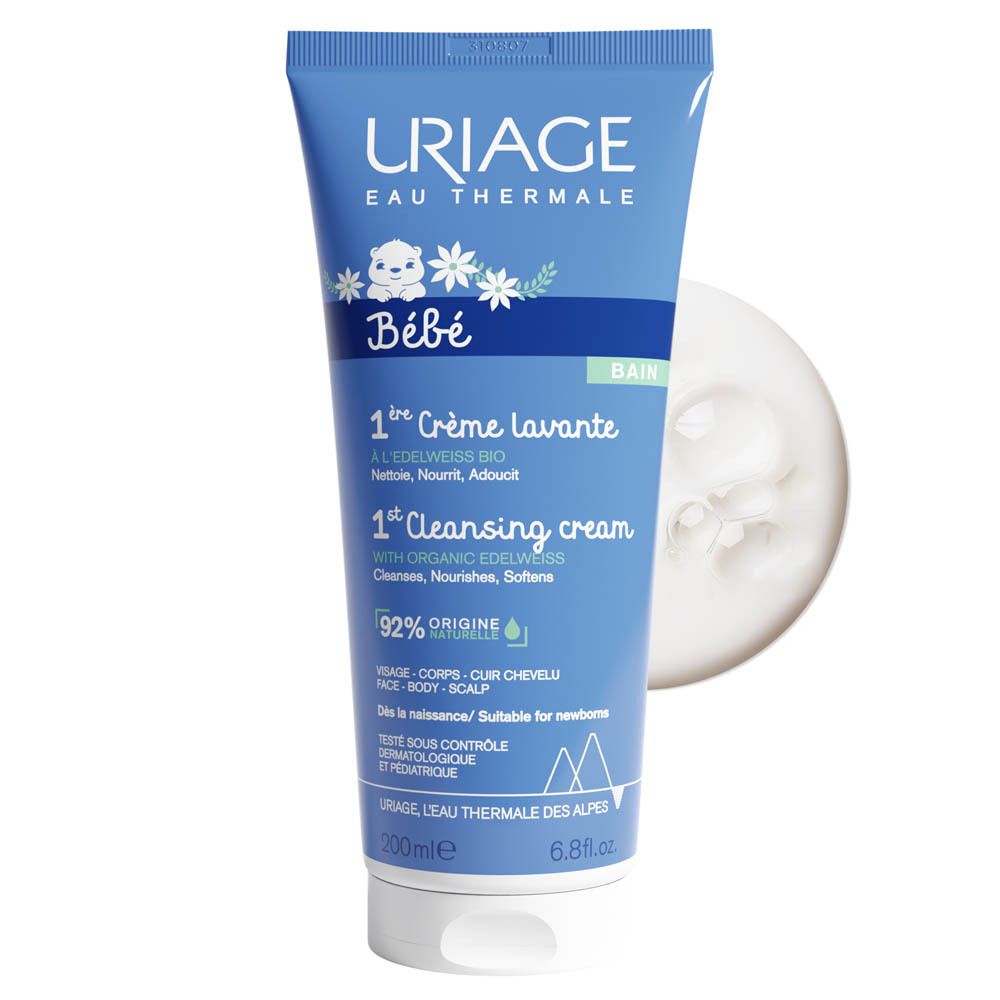 Tube bleu Uriage Bébé 1ère Crème lavante et une petite quantité de crème à côté.