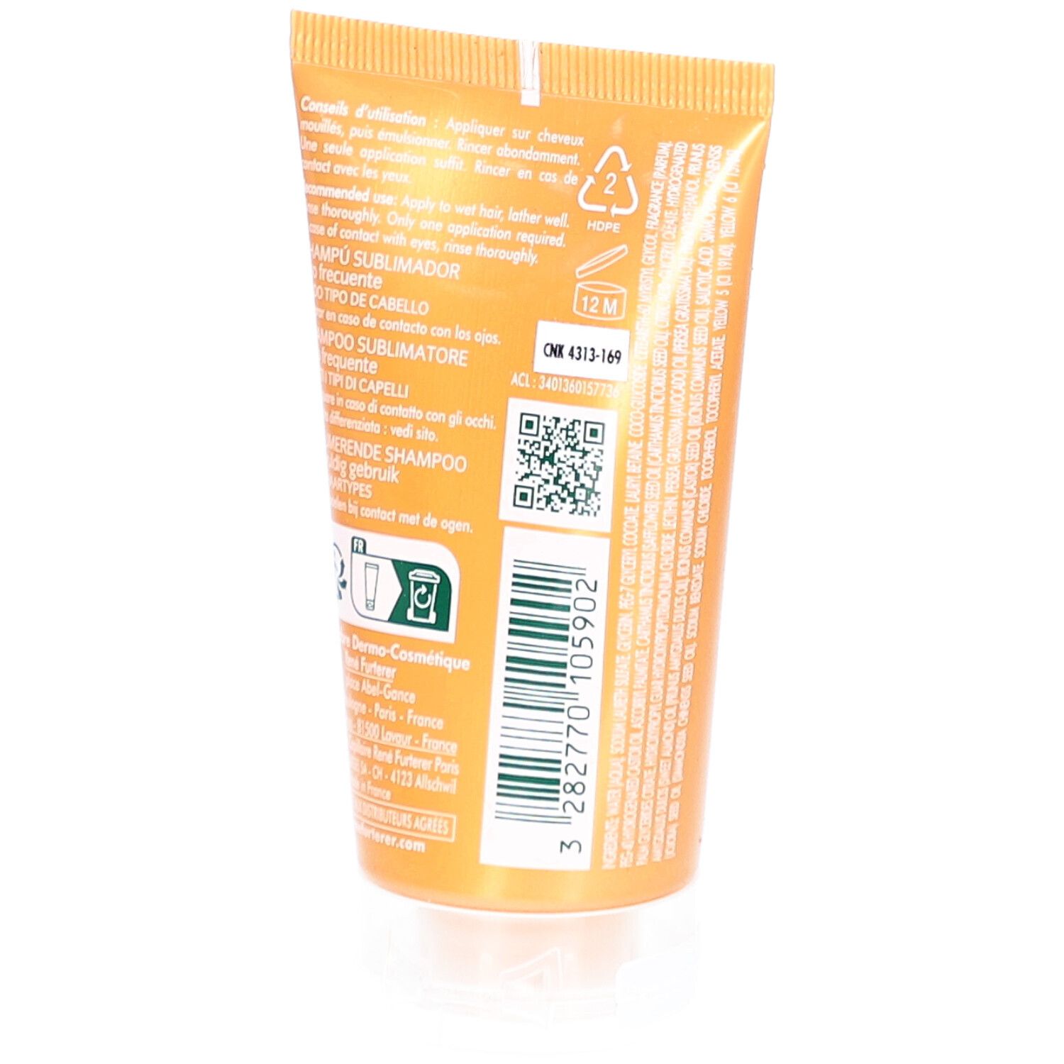 Achterkant van de gouden tube. Tekst en symbolen. Transparante dop. QR-code en batchnummer.