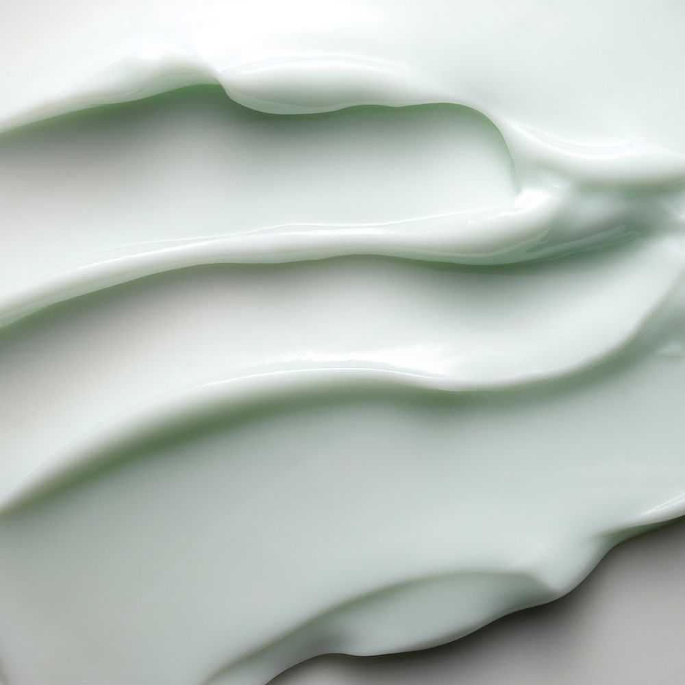 Close-up van crème. Lichtgroene textuur.