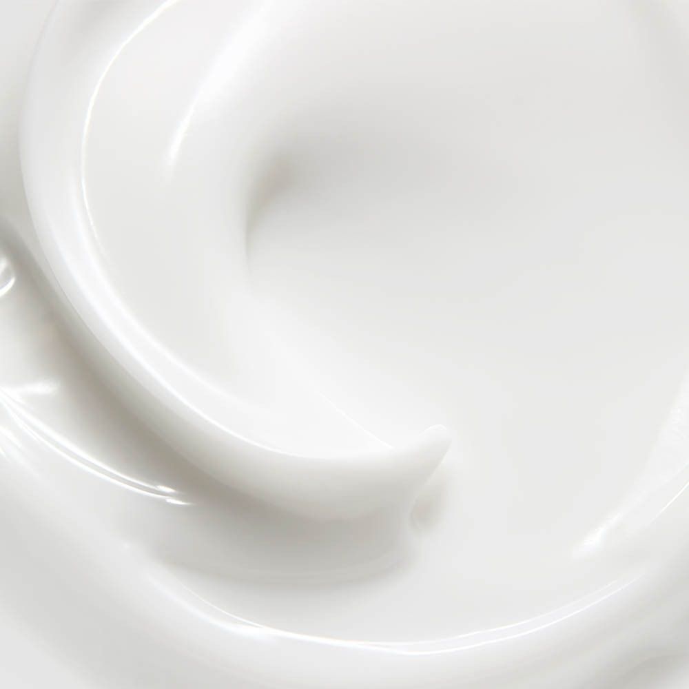 Gros plan d'une crème blanche. Texture crémeuse. Surface brillante. Forme tourbillonnante.