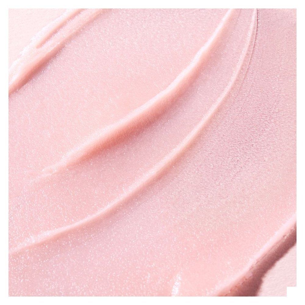 Nuxe lippenbalsem: glazen pot met roze deksel, etiket met Franse tekst.
