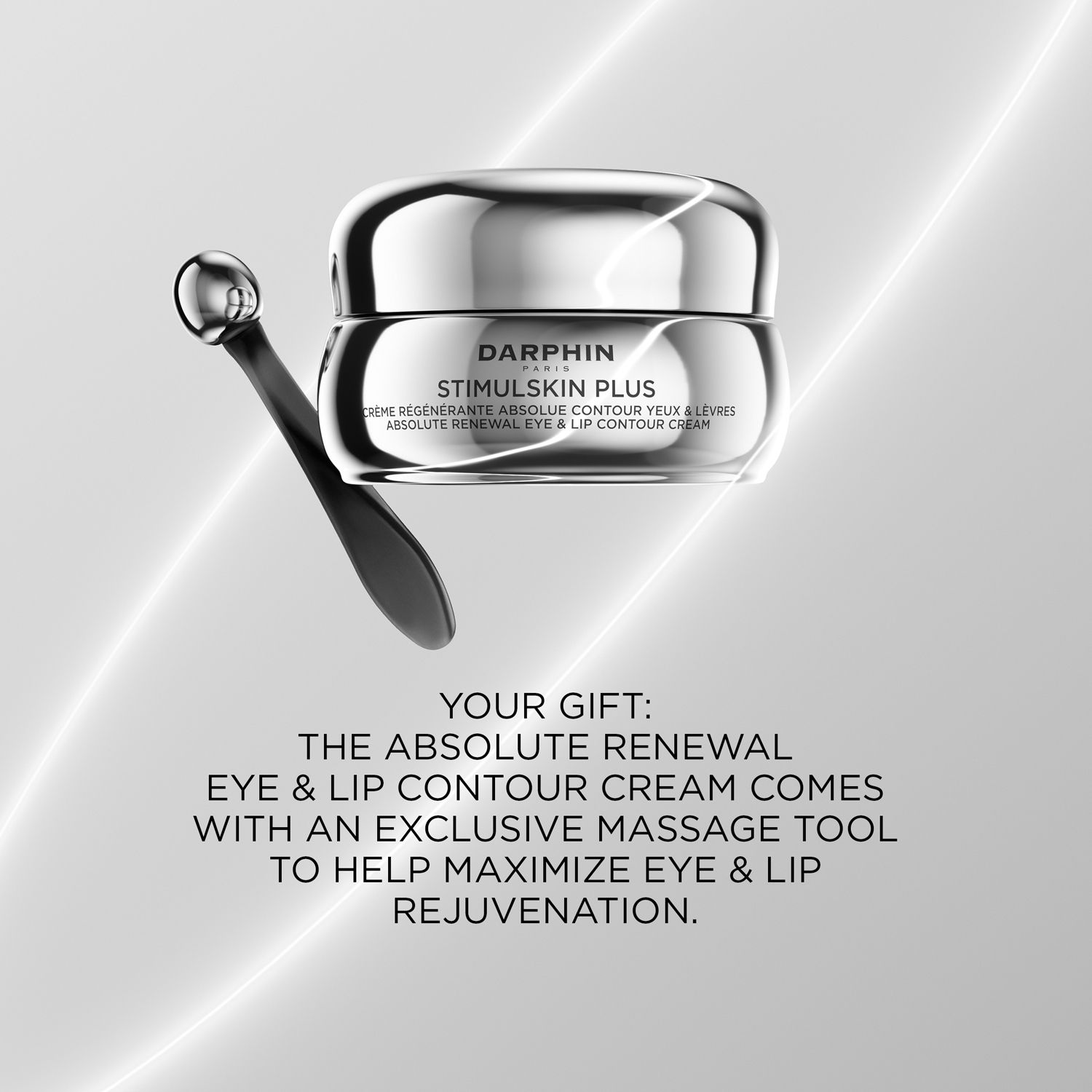 Crèmepot met zilverkleurig deksel en massage-tool. Tekst: "THE ABSOLUTE RENEWAL EYE & LIP CONTOUR CREAM COMES WITH AN EXCLUSIVE MASSAGE TOOL".