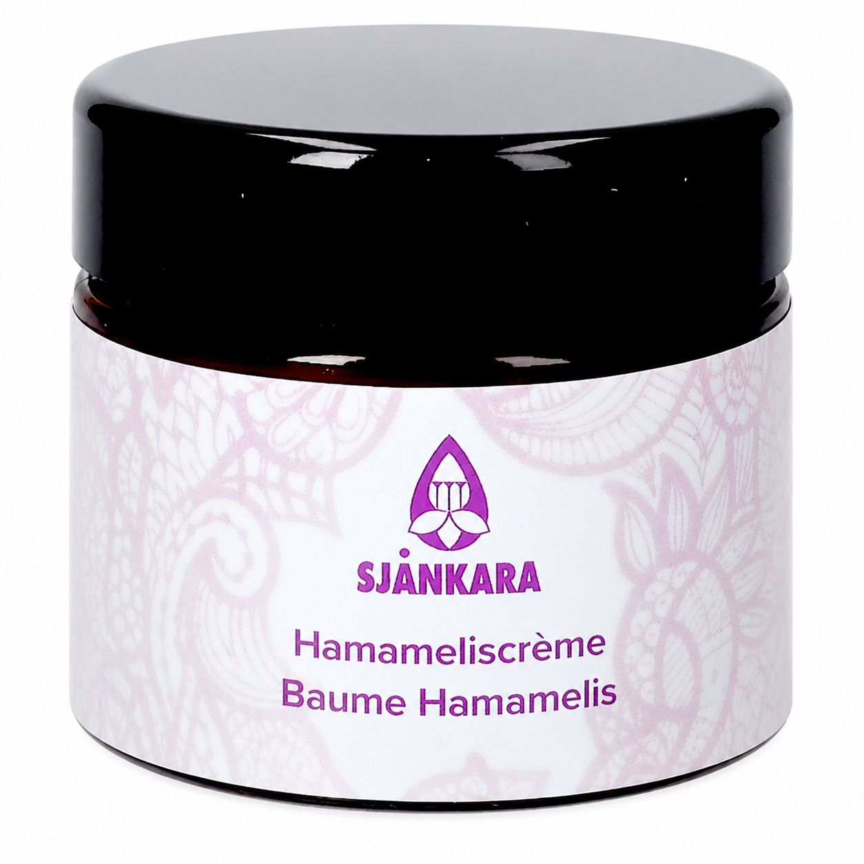 Donkere pot met zwarte deksel. Etiket met paars logo en tekst: Sjankara, Hamameliscrème, Baume Hamamelis.