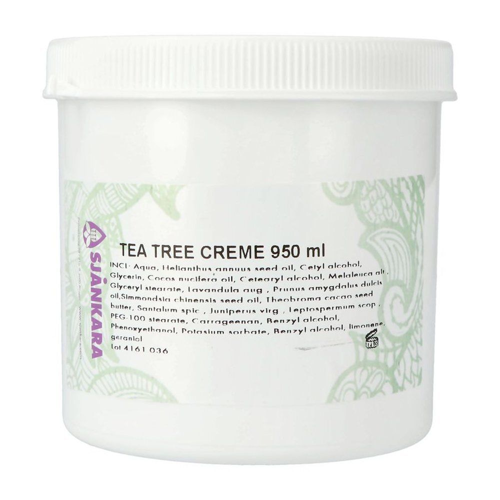 Pot blanc avec l'inscription TEA TREE CREME 950 ml. Marque Sjankara. Ornements verts et liste d'ingrédients.