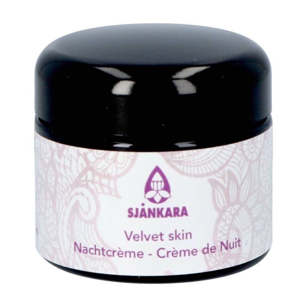 Crèmepot. Sjankara Velvet Skin Crème de Nuit. Zwart deksel, wit etiket, paars logo en tekst.