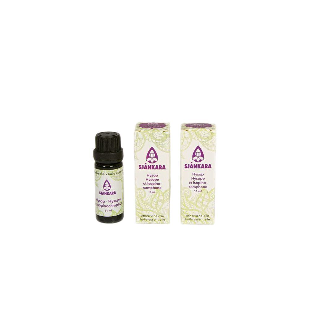 Drie flessen. Een bruine glazen fles met zwarte dop en twee dozen met paars logo en tekst.