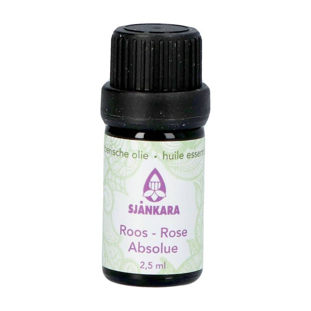 Flacon en verre brun avec bouchon noir. Étiquette avec logo et texte: Roos-Rose Absolue, 2,5 ml. Inscription: huiles essentielles.