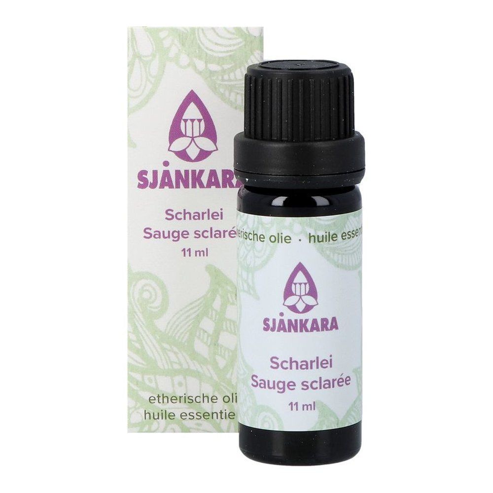 Bruine glazen fles en verpakking. Verpakking met paars logo en tekst. "Sjankara Scharlei Sauge sclarée". 11 ml.