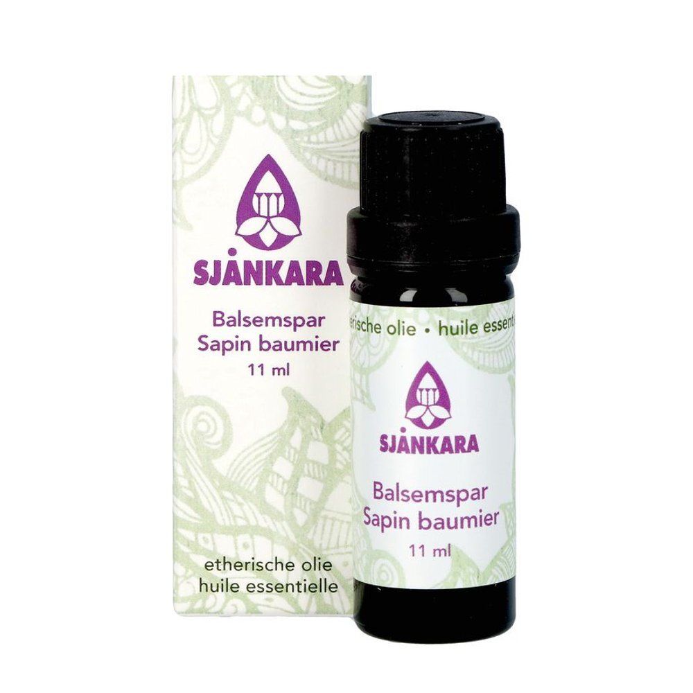 Bruine glazen fles en doos. Opschrift: SJANKARA, Balsamspar, Sapin baumier, 11 ml. Met bloemmotief en logo.