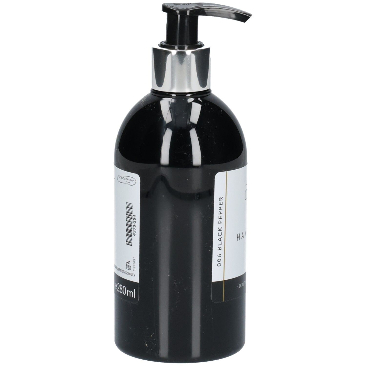 Flacon de lavage des mains noir avec pompe argentée. Étiquette avec informations produit et code-barres. Texte: 006 Black Pepper, 280ml.