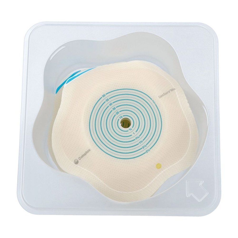 Twee ronde, huidkleurige stoma-platen met blauwe markeringen en maatindicaties, in een doorzichtige plastic verpakking.