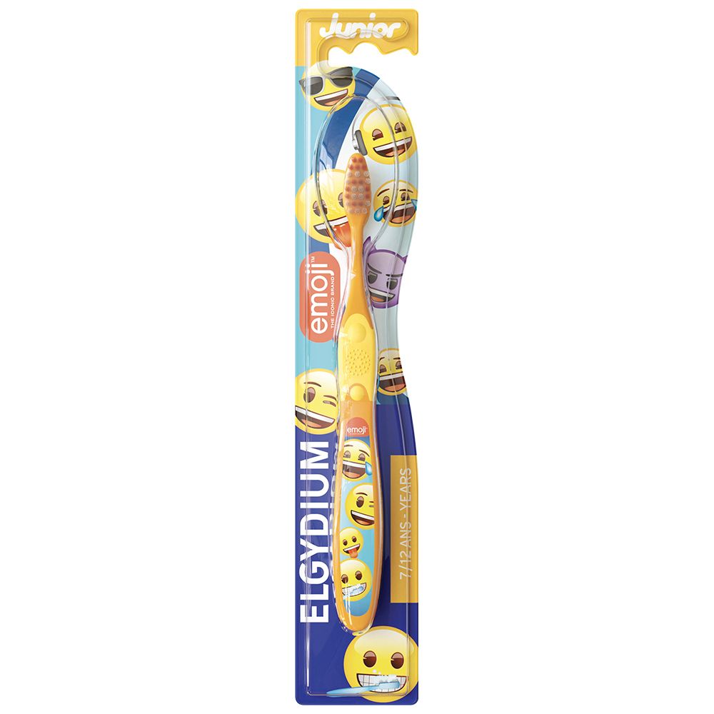 Gele tandenborstel met Emoji-motieven en ELGYDIUM Junior opdruk, voor kinderen van 7-12 jaar.