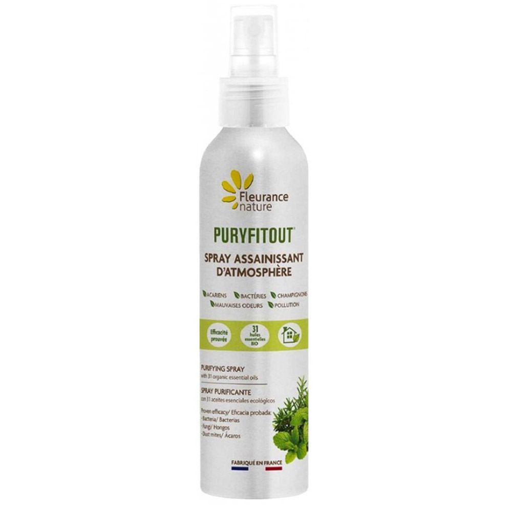 Zilveren spuitfles met witte sproeikop. Opschrift: Puryfitout, spray assainissant d'atmosphère. Logo: gele bloem.