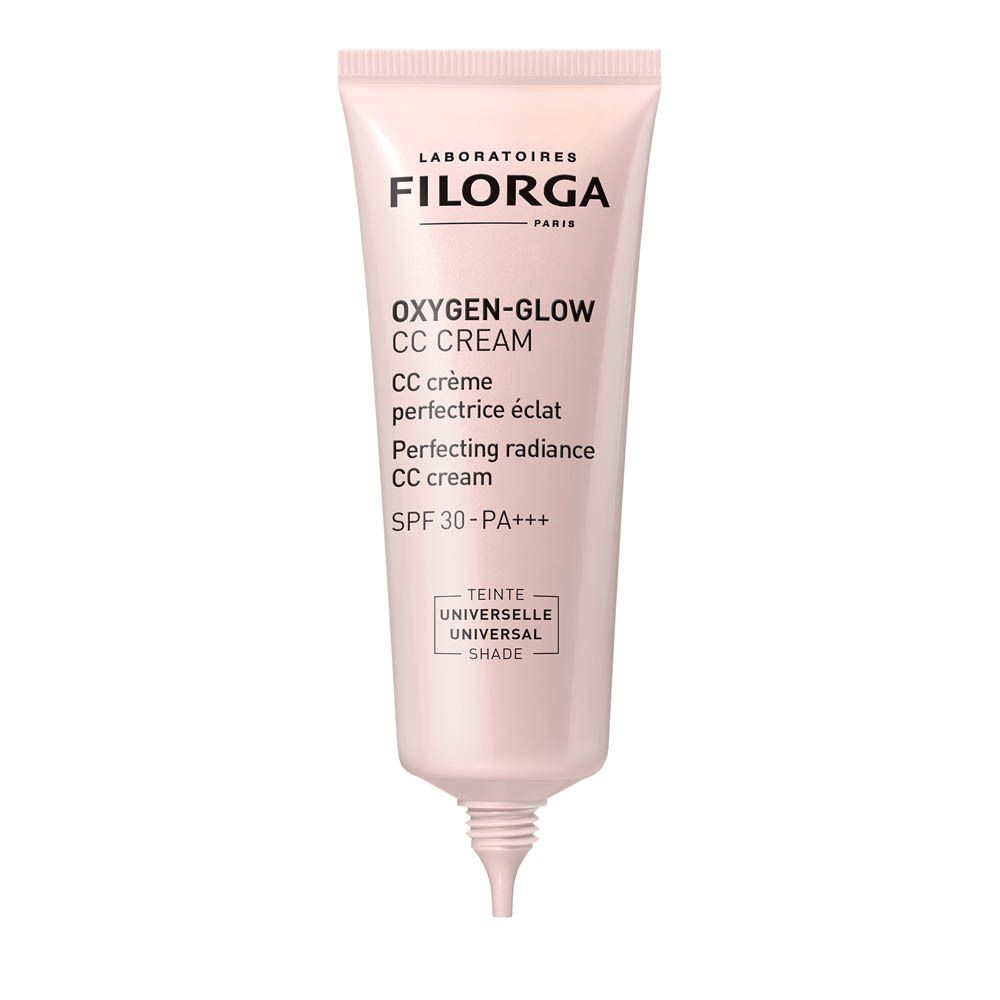 Tube rose FILORGA Oxygen-Glow CC Cream. Texte: CC crème perfectrice éclat, SPF30-PA+++. Sur une assiette blanche.