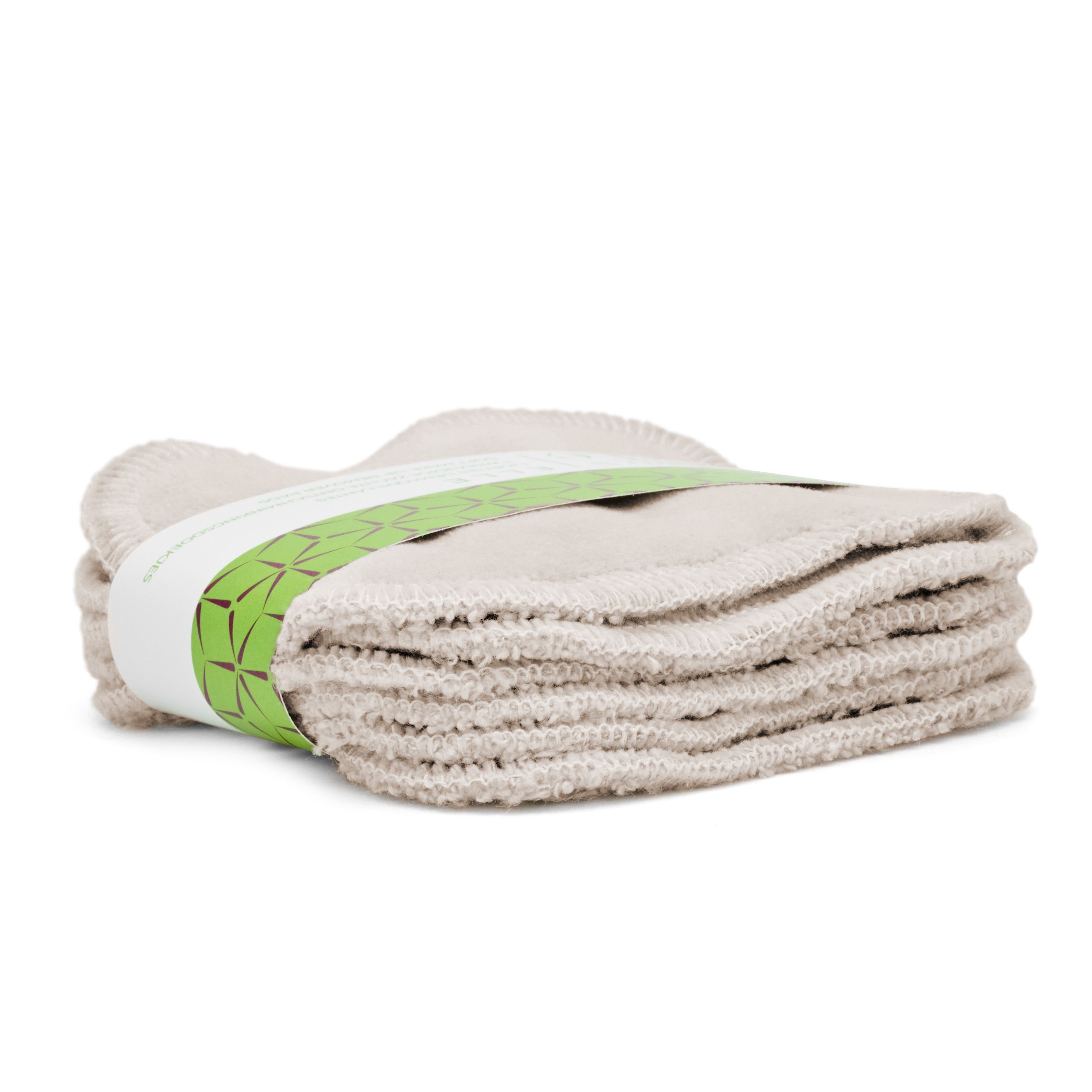 Stapel make-up remover pads, met groene band. Zijaanzicht. Opschrift: Maison Éole, ELLE, Lingettes Démaquillantes.